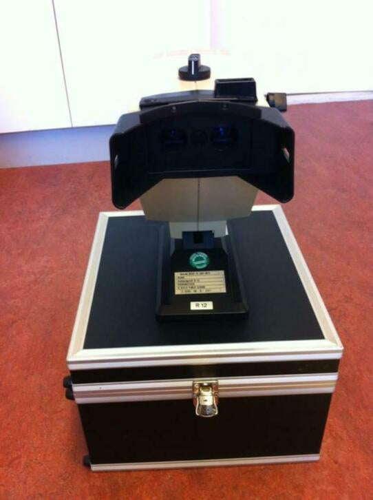 Rodenstock oogtest apparaat met testschijf in koffer
